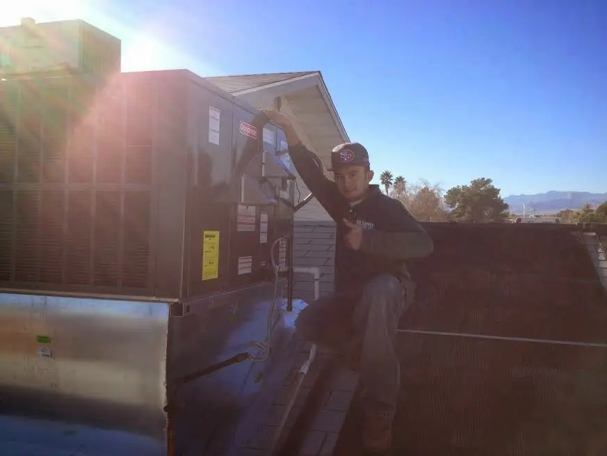 HVAC technician performing Boiler Repair on a rooftop unit in Contra Costa Centre